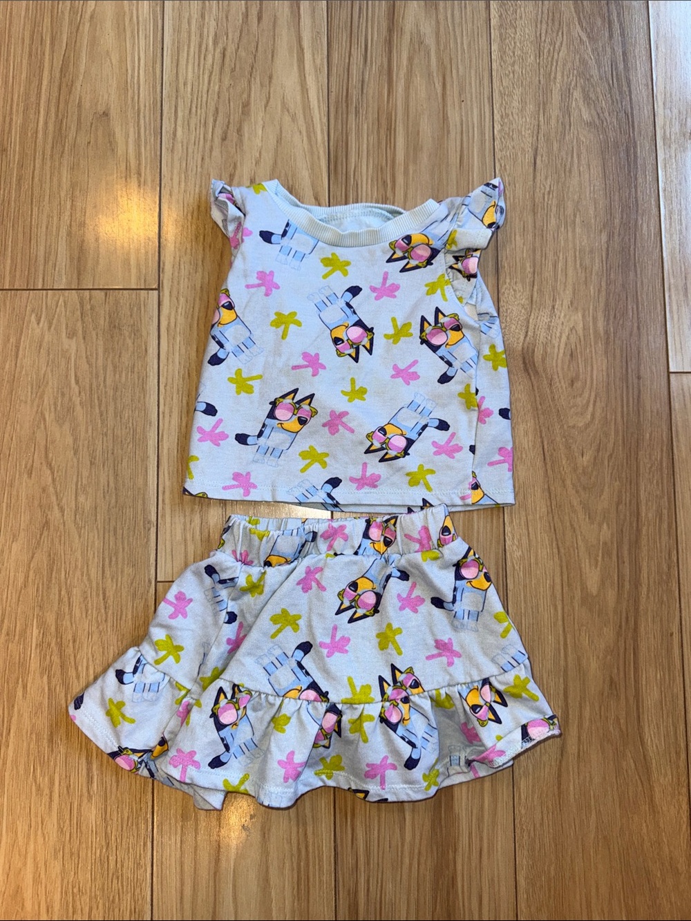 Girls Bluey Two-Piece Top & Skirt Set in blue with Pink, Yellow & Blue Print